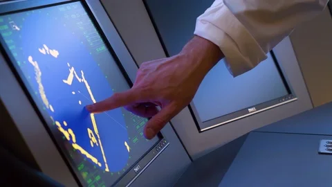 A ships navigator pointing towards a digital radar screen during a Stock Footage 107088273