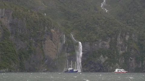 Ships passing under a waterfall Stock Footage 98678570
