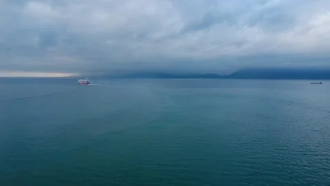 Ships Sailing on Open Sea Under Cloudy Horizon Near Island Stock Footage 343992746