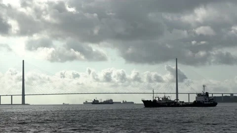 Ships under the bridge. Ship sails by in silhouette. Bunkering vessel. Huge Stock Footage 166002830
