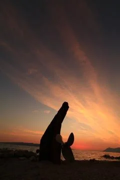 Shipwreck against the background of the setting sun Stock Photos