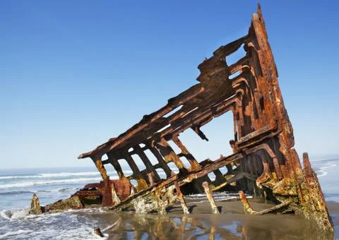 Shipwreck on a beach Stock Photos
