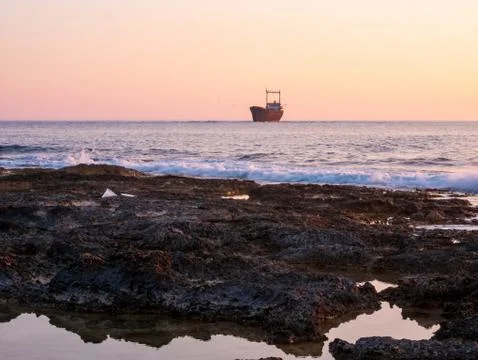 Shipwreck at sunset Stock Photos