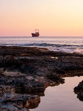 Shipwreck at sunset Stock Photos