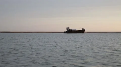 Shipwrecked boat on horizon Stock Footage 47673428
