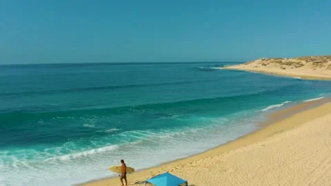 SHIPWRECKS LOS CABOS BCS MEXICO-2021: A Man Carrying A Yellow Surfboard While Stock Footage 168837733