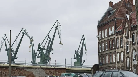 Shipyard cranes viewed from empty neighborhood in the harbor district. Stock Footage 69937688