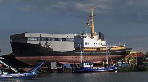 Shipyard with ship in dry dock, large industrial ship + pan basin Stock Footage 32725341