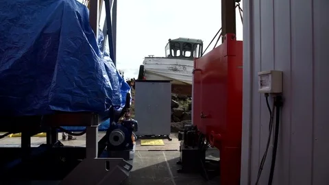Shipyard, a small ship is lifted by a crane. Video shots with the stabilizer Stock Footage 69815559