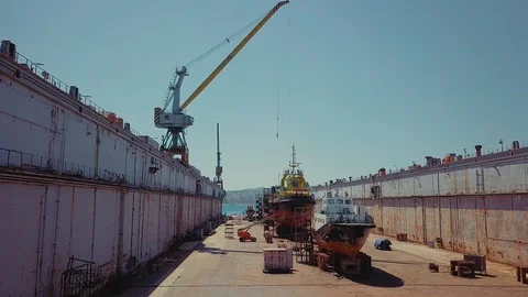 Shipyard. Three Ships in Repair in a Floating Dock. Overhaul and Modernization Stock Footage 95874276
