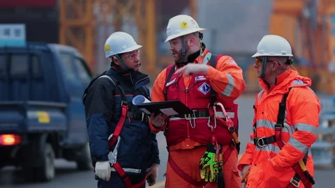 Shipyard workers discuss a work plan with an engineer. Stock Footage 231220816
