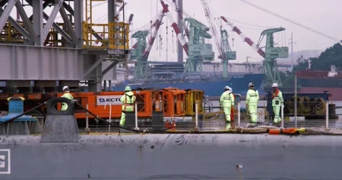 Shipyard workers inspect the deck of the ship. Stock Footage 165620832