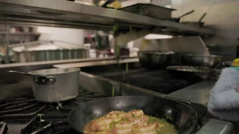 Shirimp in a frying pan in a restaurant kitchen, garnish, chef. 4K 24FPS Stock Footage 237340530