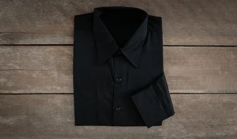 Shirt on wooden background Stock Photos