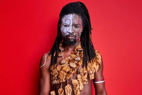 Shirtless african man with shaman aborigen make-up confidently looking at camera Stock Photos