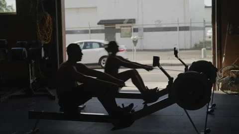 Shirtless Athletes Rowing on Machines at... | Stock Video | Pond5
