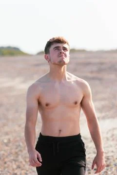 Shirtless on a beach Stock Photos