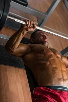 Shirtless body builder doing bench press for chest Stock Photos