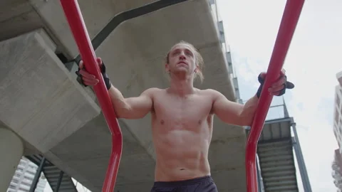 Shirtless Bodybuilder Resting after Exercises on Parallel Bars Stock-Footage 260048262