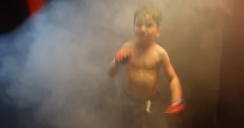 Shirtless boy hitting the punching bag in gym Video stock 112078949
