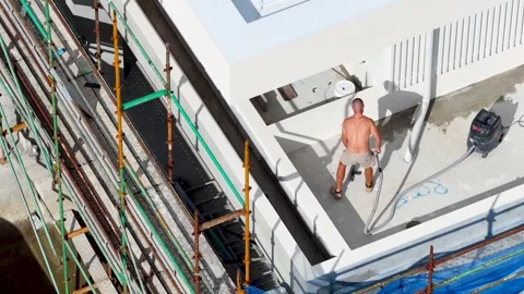 Shirtless Construction Worker Cleaning Flat Roof With Industrial Vacuum Cleaner Stock Footage 339119252