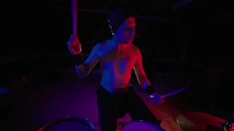 Shirtless drummer playing drums during live rock concert Stock Footage 327854781