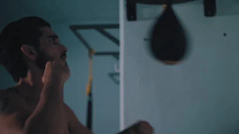 Shirtless fighter practices on speed ball Stock Footage 275438157