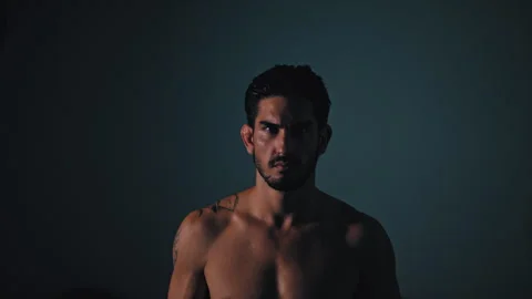 Shirtless guy looks up at viewer Stock Footage 275434324