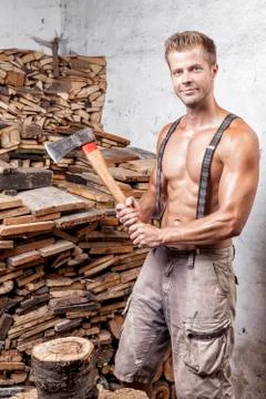 Shirtless lumberjack with an axe Stock Photos