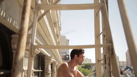 Shirtless man balcony 01 Stock Footage 76735060