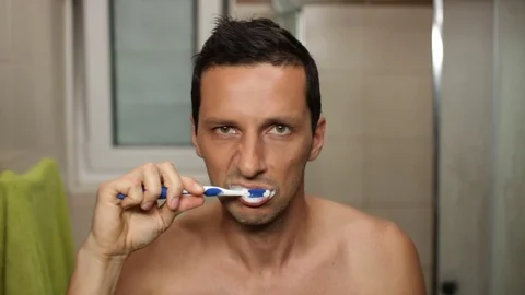 Shirtless man brushing his teeth. High definition video. Stock Footage 79497284