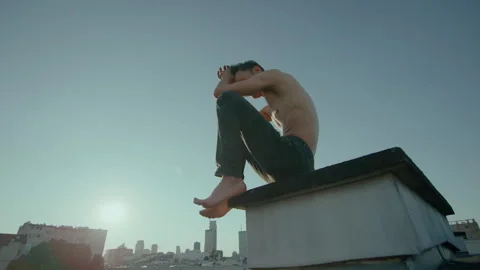 Shirtless Man in Deep Though on Rooftop, CInematic Slow Motion Video stock 274252886