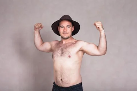 Shirtless man in hat posing and showing his strong body Stock Photos