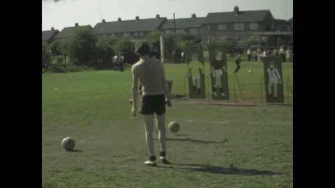 Shirtless man practicing penalty kicks in 1977 silver jubilee celebration Stock Footage 309450461