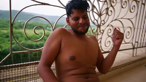 Shirtless man Sitting down in gallery crying Stock Footage 297238931