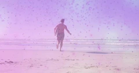 Shirtless man starting run, running with board into waves to surf, pink overlay 스톡 동영상 331235258