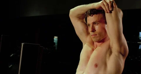Shirtless man stretches his arms and shoulders Video stock 83327770