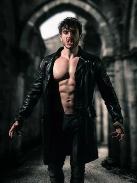 Shirtless man walking down dark alleyway Stock Photos