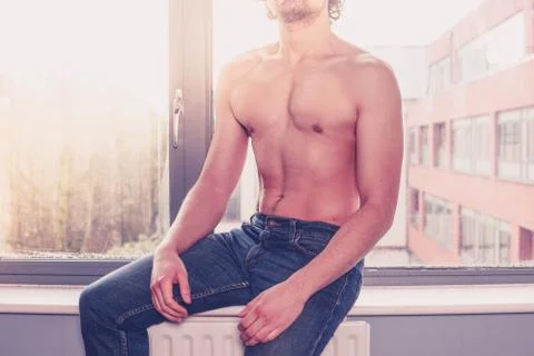 Shirtless man at the window Stock Photos