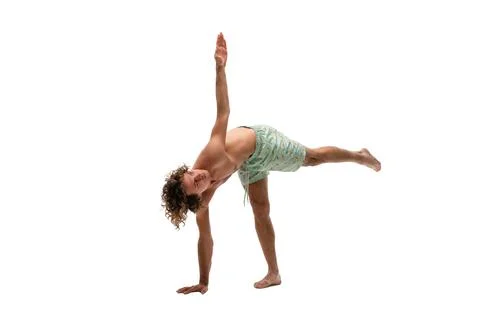 Shirtless young man doing Half Moon pose Stock Photos