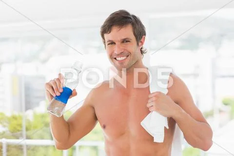 Shirtless young man with towel drinking water Stock Photos