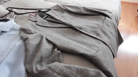 Shirts and coat in the bed Stock Footage 85072242