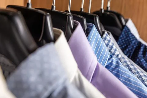 Shirts hanging in a closet. Stock Photos