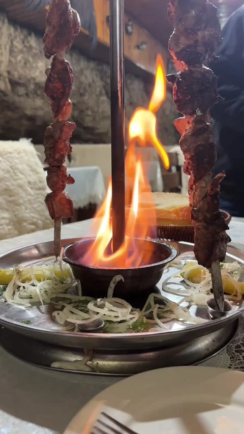Shish kebab is served on a platter with fire Stock Footage 276257527