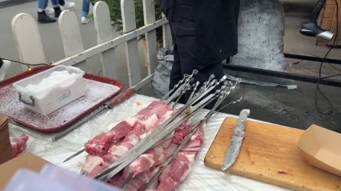 Shish kebab on table. Raw fresh meat beef, pork, lamb on skewer, cutting board Stock Footage 262706282