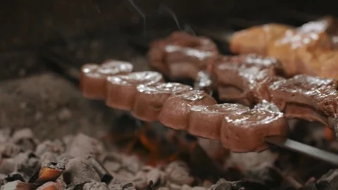 Shish kebabs from different types of meat, on skewers, cooked on charcoal Stock Footage 76845055