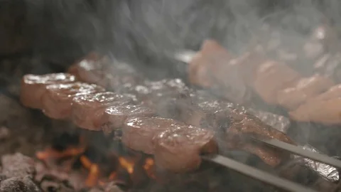 Shish kebabs from different types of meat, on skewers, cooked on charcoal Stock Footage 76846708