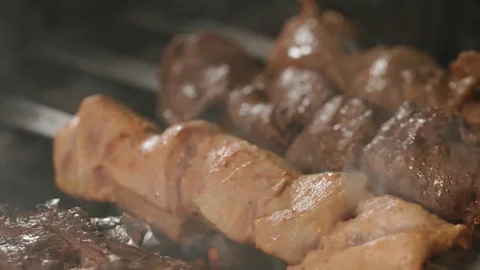 Shish kebabs from different types of meat, on skewers, cooked on charcoal Stock Footage 76847311