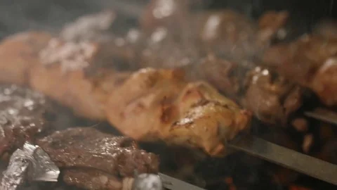Shish kebabs from different types of meat, on skewers, cooked on charcoal Stock Footage 76848400