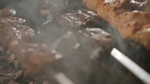 Shish kebabs from different types of meat, on skewers, cooked on charcoal Stock Footage 76849537